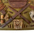Original U.S. WWII Outstanding Inert Battle of the Bulge Relic Display Board with Bayonets, Cartridges, BAR Magazine, Artillery Fuzes, and More - 23 ⅞ x 23 ⅞”
